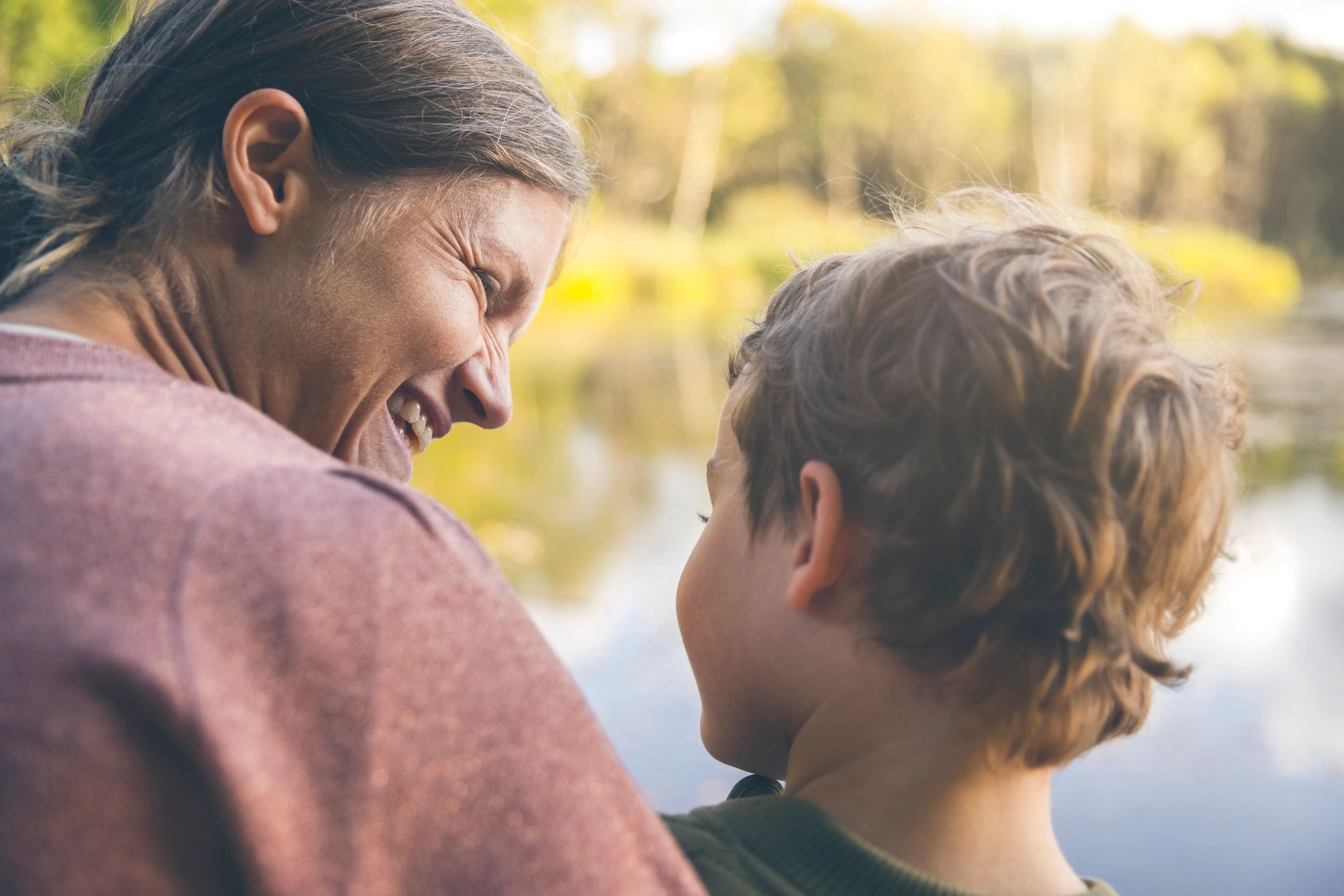 Supportive moment between a mother and her autistic son outdoors