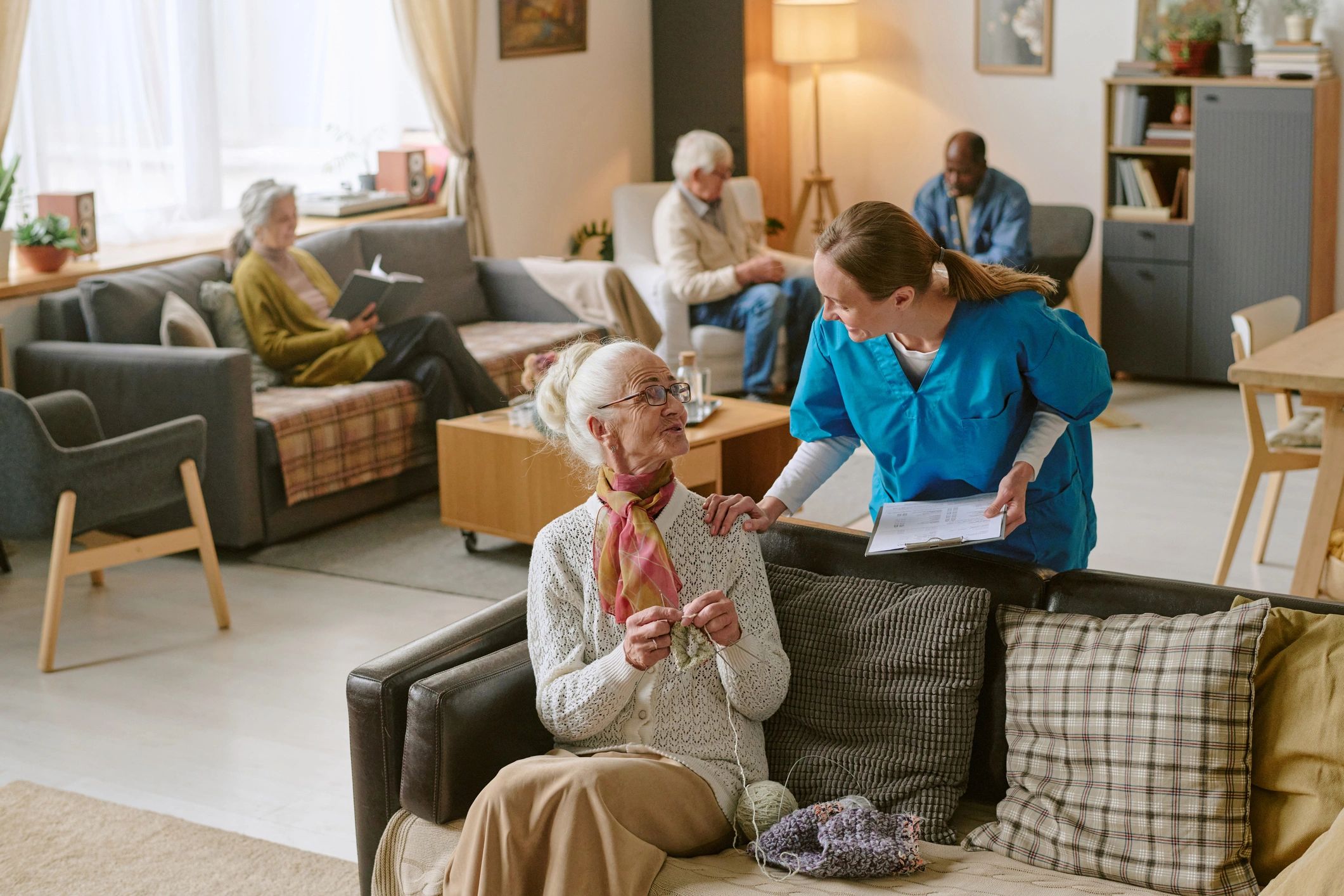 Support worker speaking with a resident in a calm setting